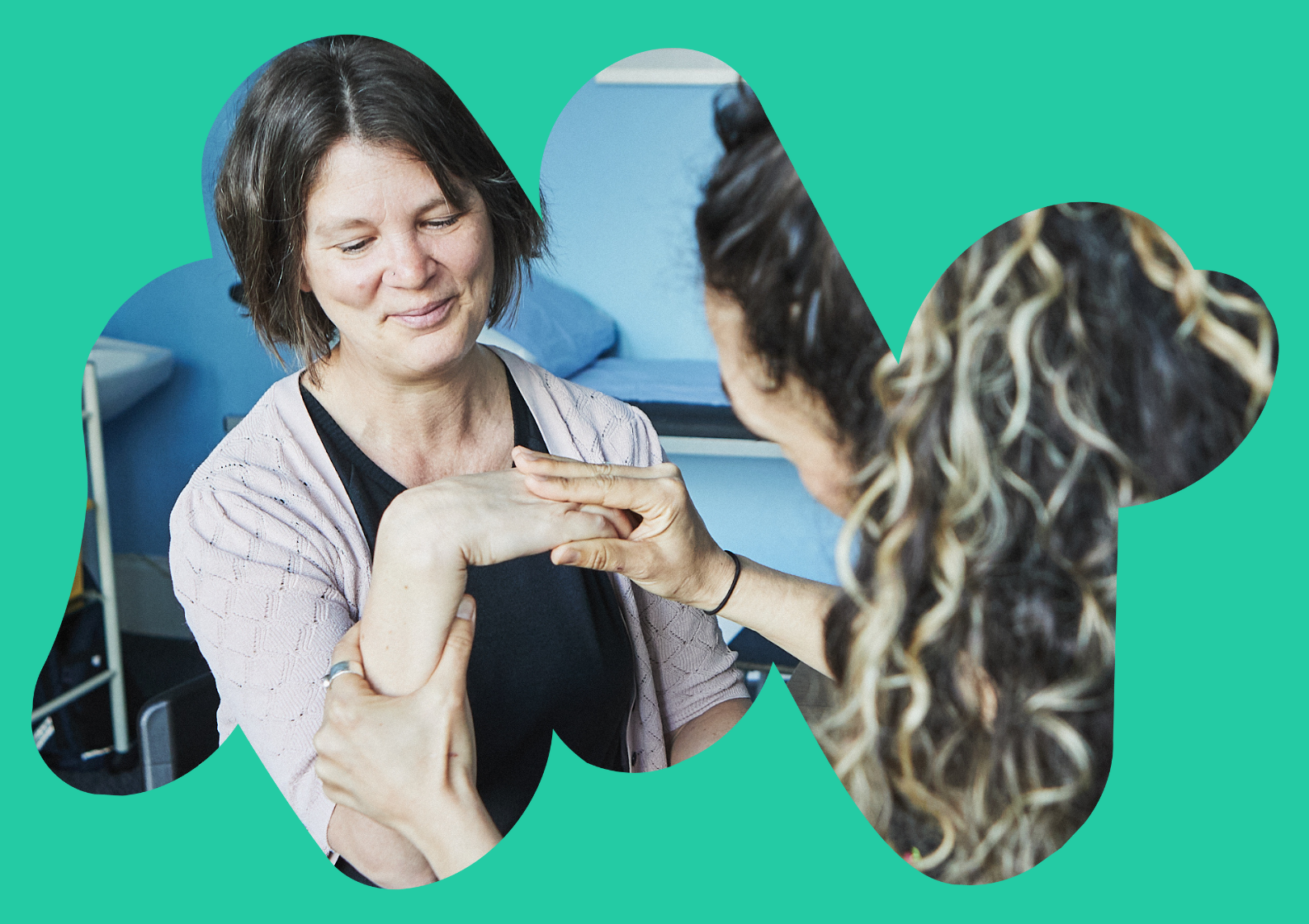 South Asian man sat talking to a care navigator in a medial consultation room
