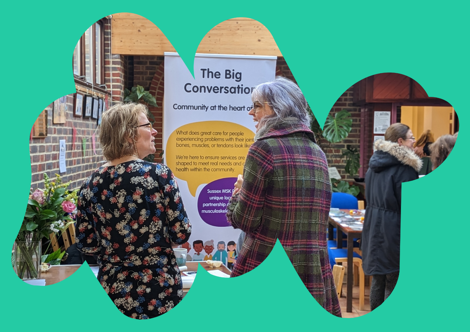 South Asian man sat talking to a care navigator in a medial consultation room
