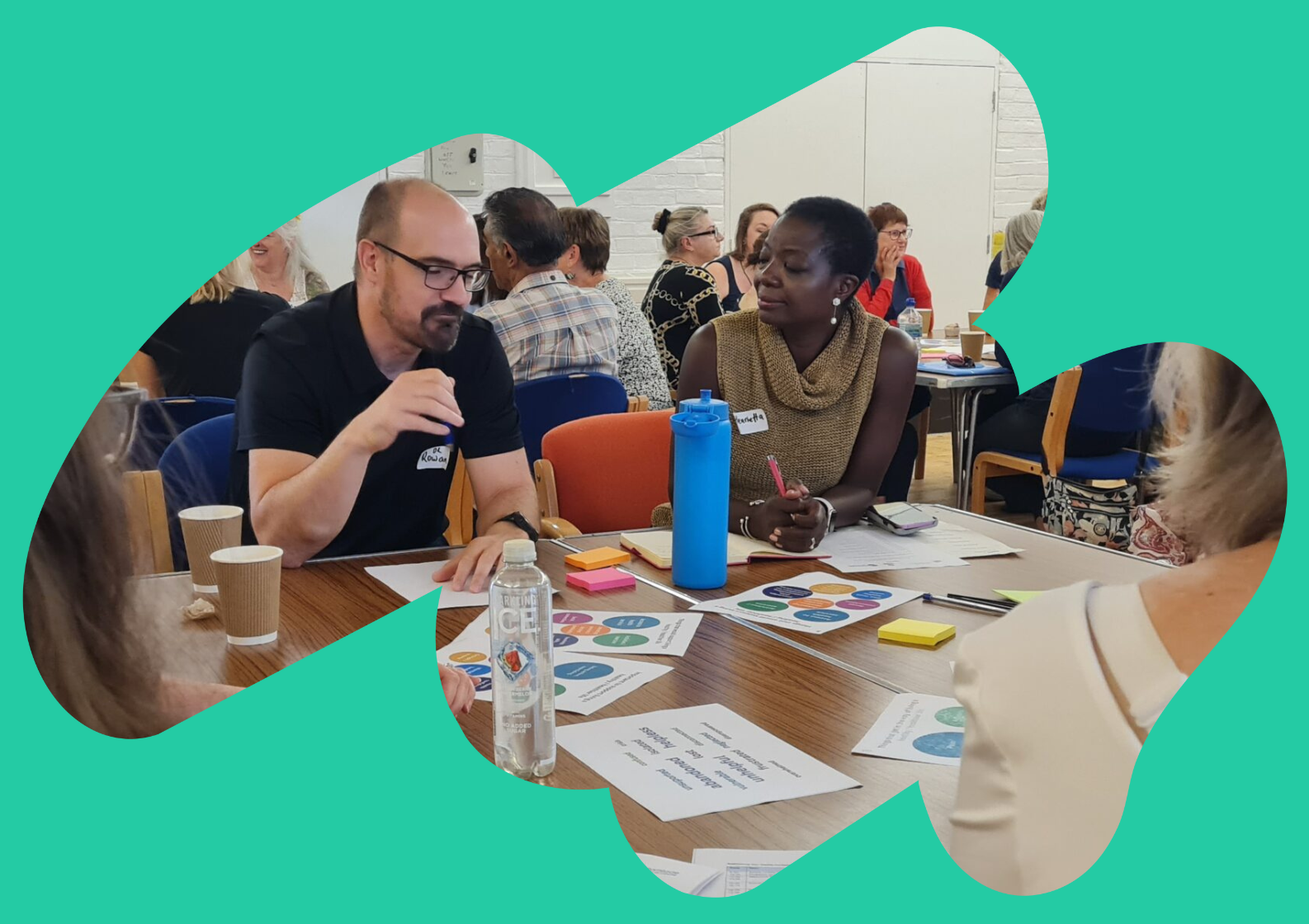 A Rethinking Our Health workshop space featuring flipcharts and whiteboards covered in colourful sticky notes. One flipchart is labelled "SOLUTIONS" with a hand-drawn lightbulb in the centre, surrounded by ideas on post-it notes. In the background, posters titled "YOUR HEALTH" and "BARRIERS" are visible, with more sticky notes and diagrams. The image is framed by an abstract teal shape.